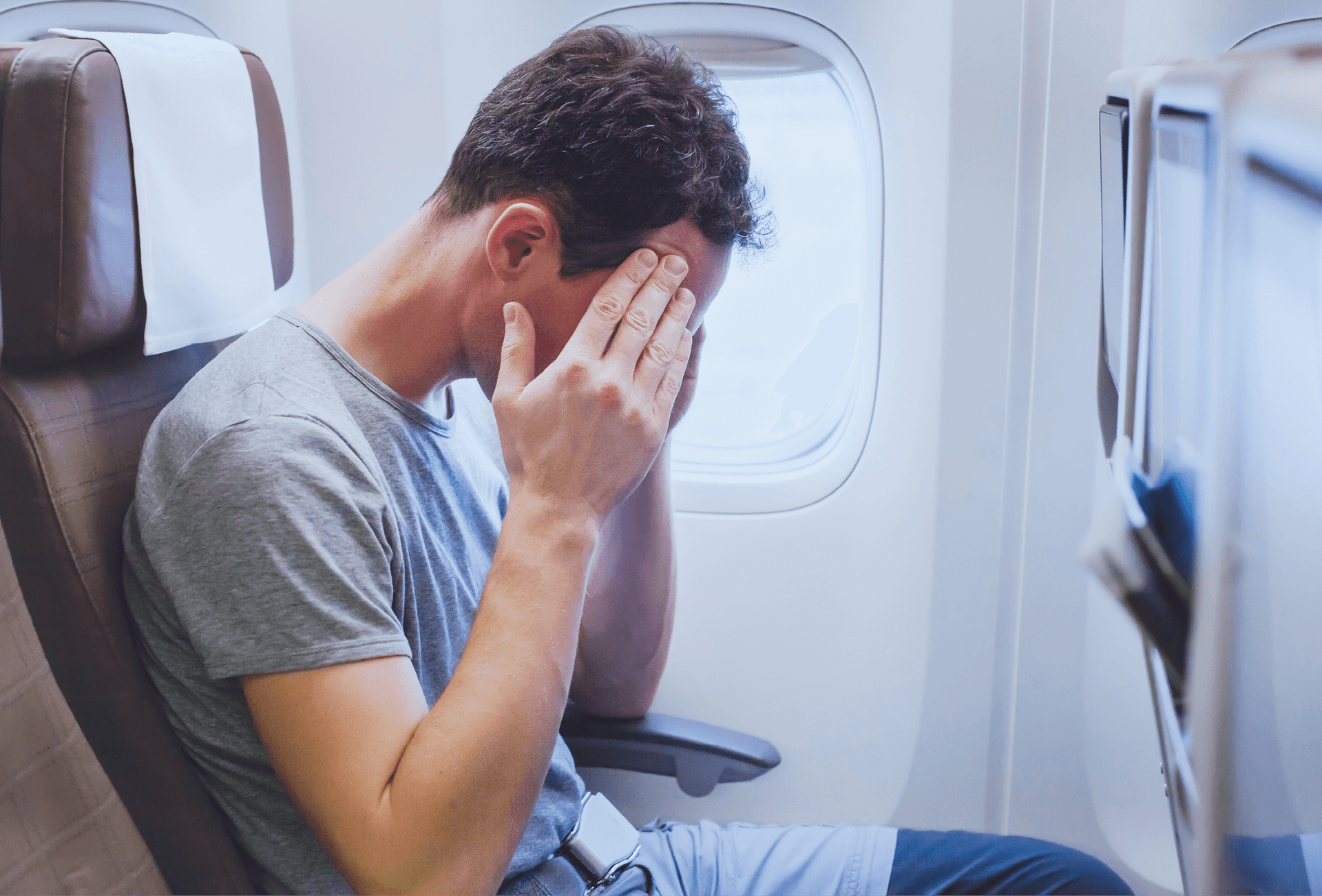 man feeling ill on plane