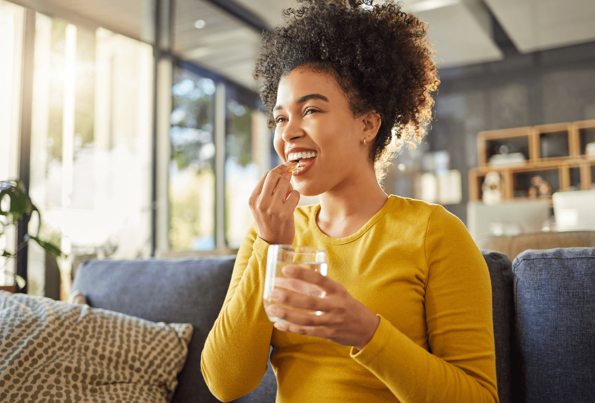 lady taking vitamin with glass of water