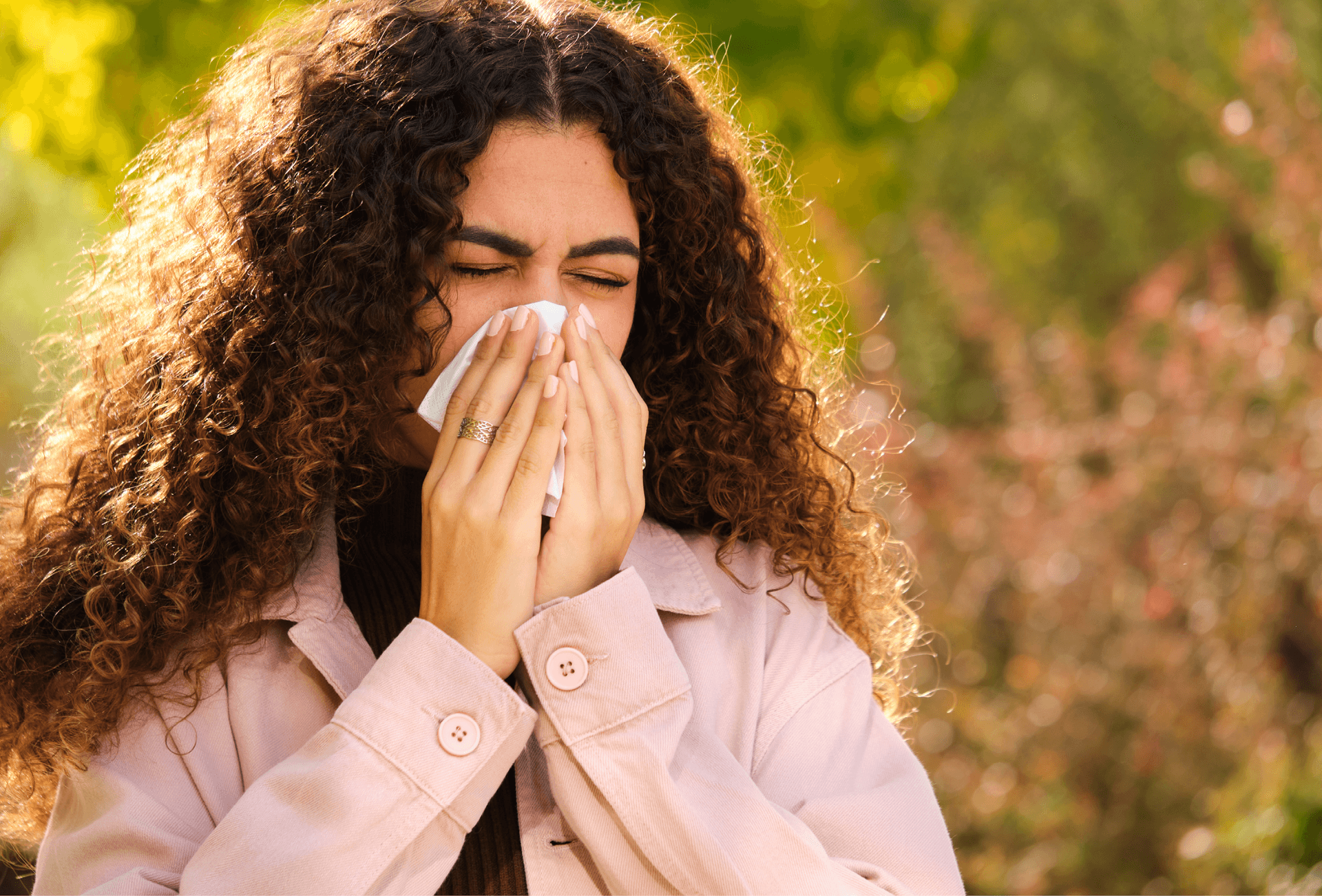 lady blowing nose in a background of grass