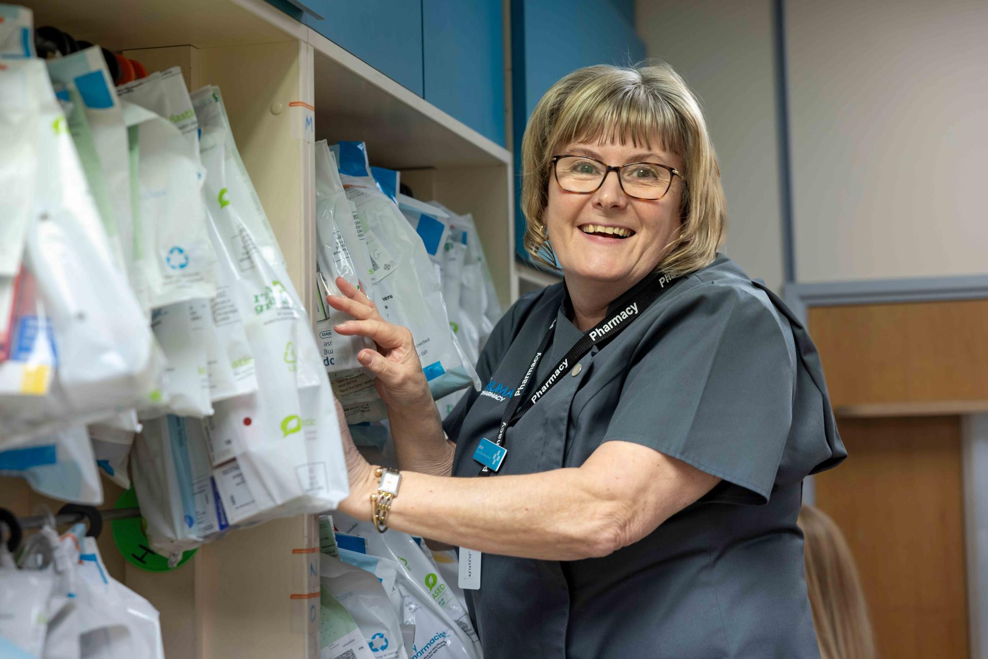 Female pharmacist smiling at the camera