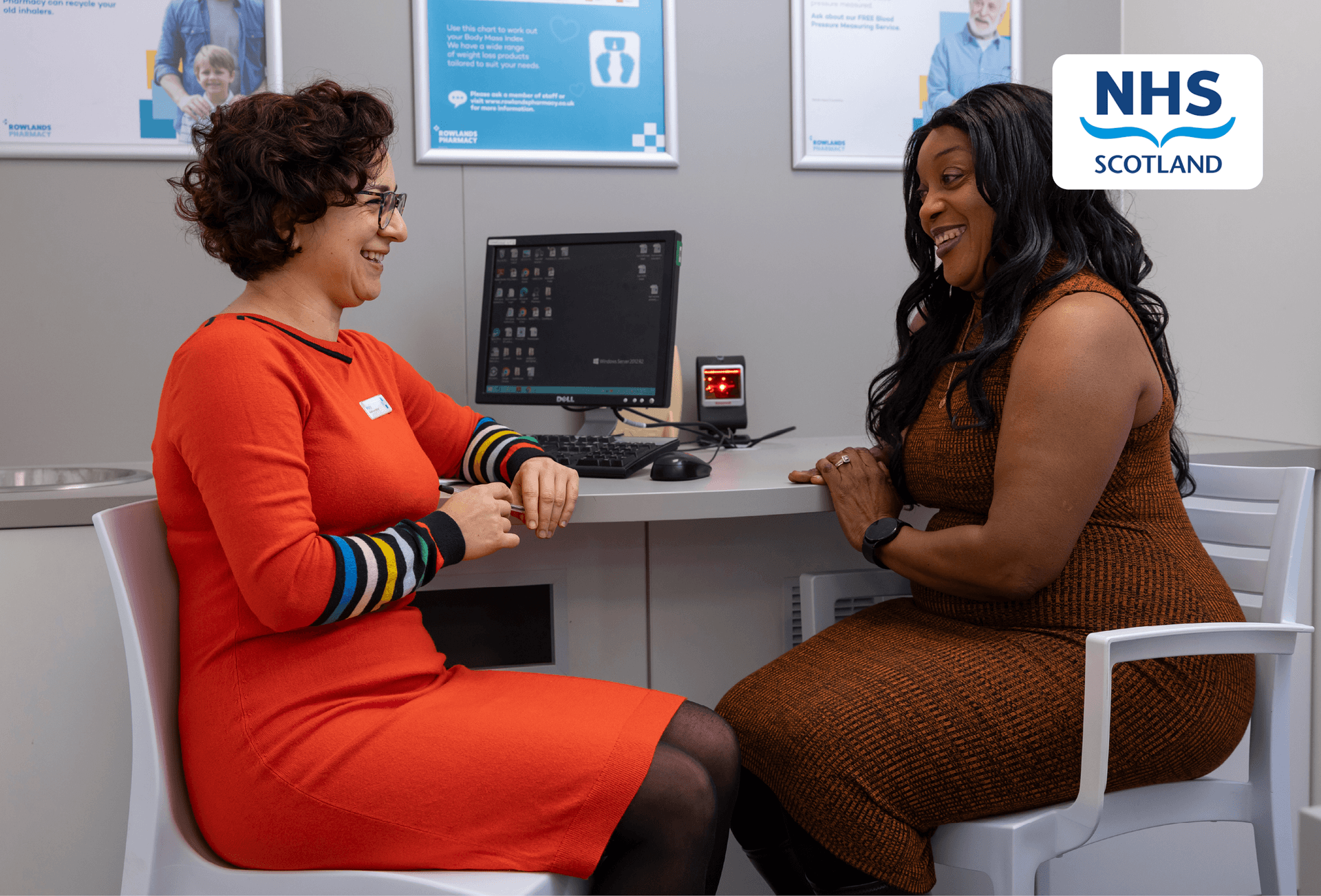 pharmacist giving advice to customer with NHS Scotland logo
