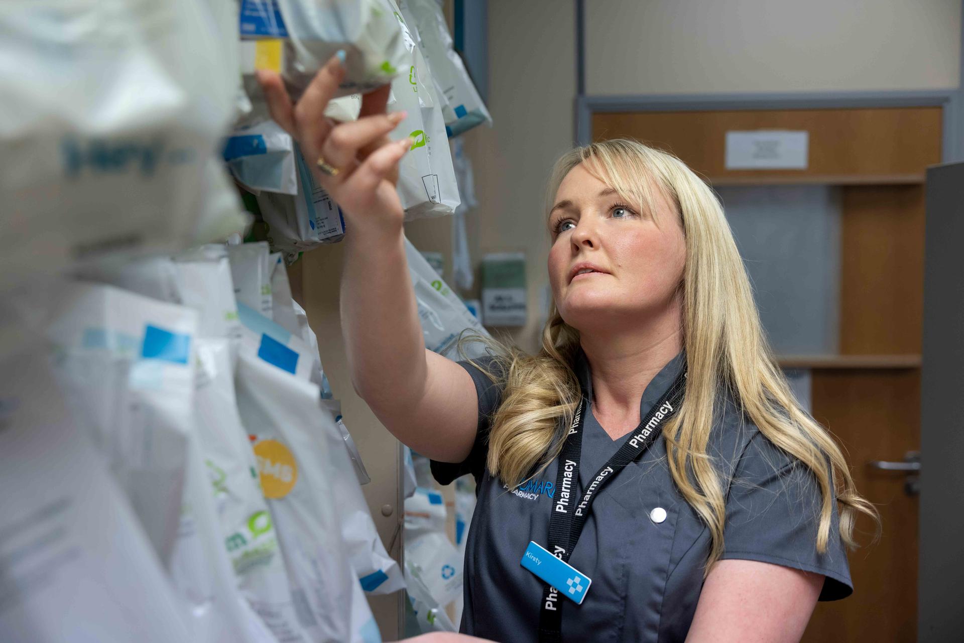 Female pharmacist checking prescriptions