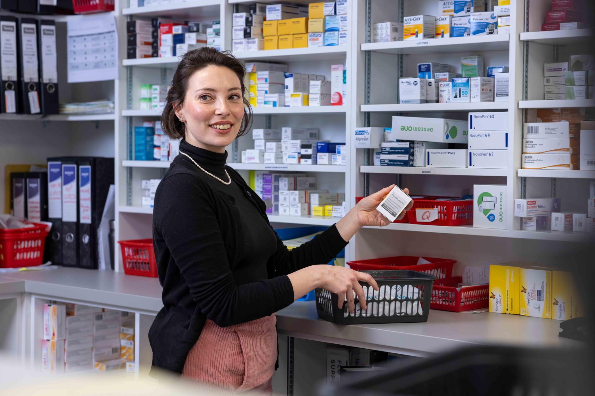 Female pharmacist handling prescriptions