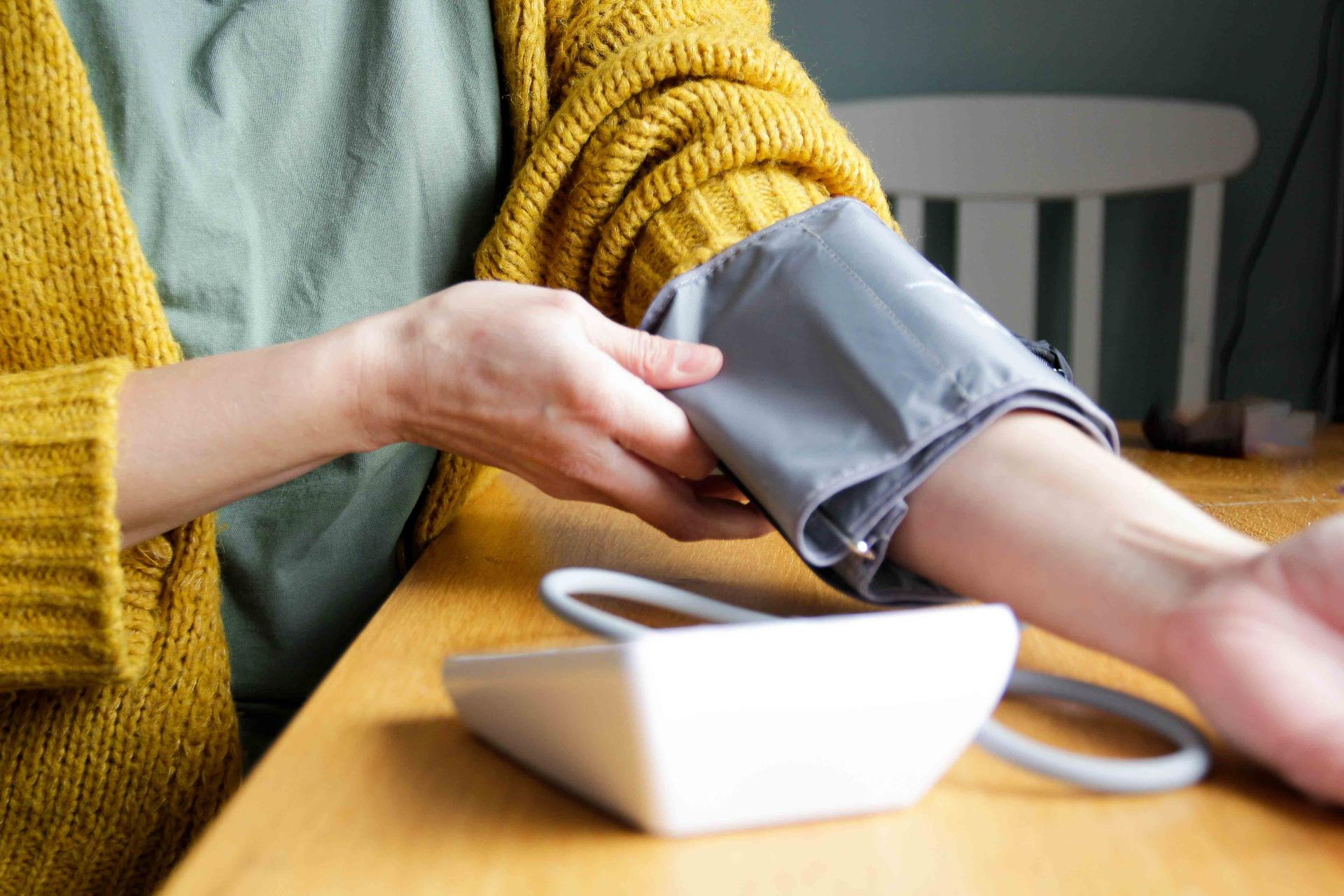 Lady testing her blood pressure at home