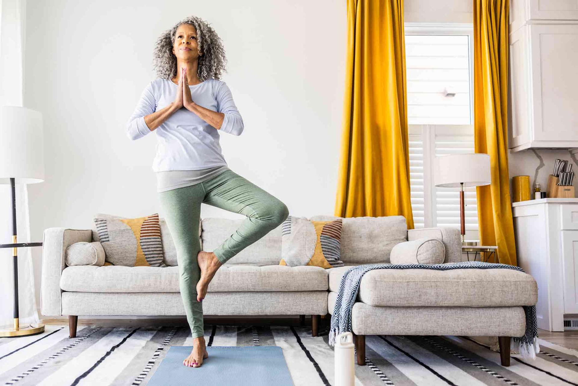 Healthy Senior Woman doing Yoga in the Morning