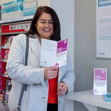 Woman reading a weight management service leaflet