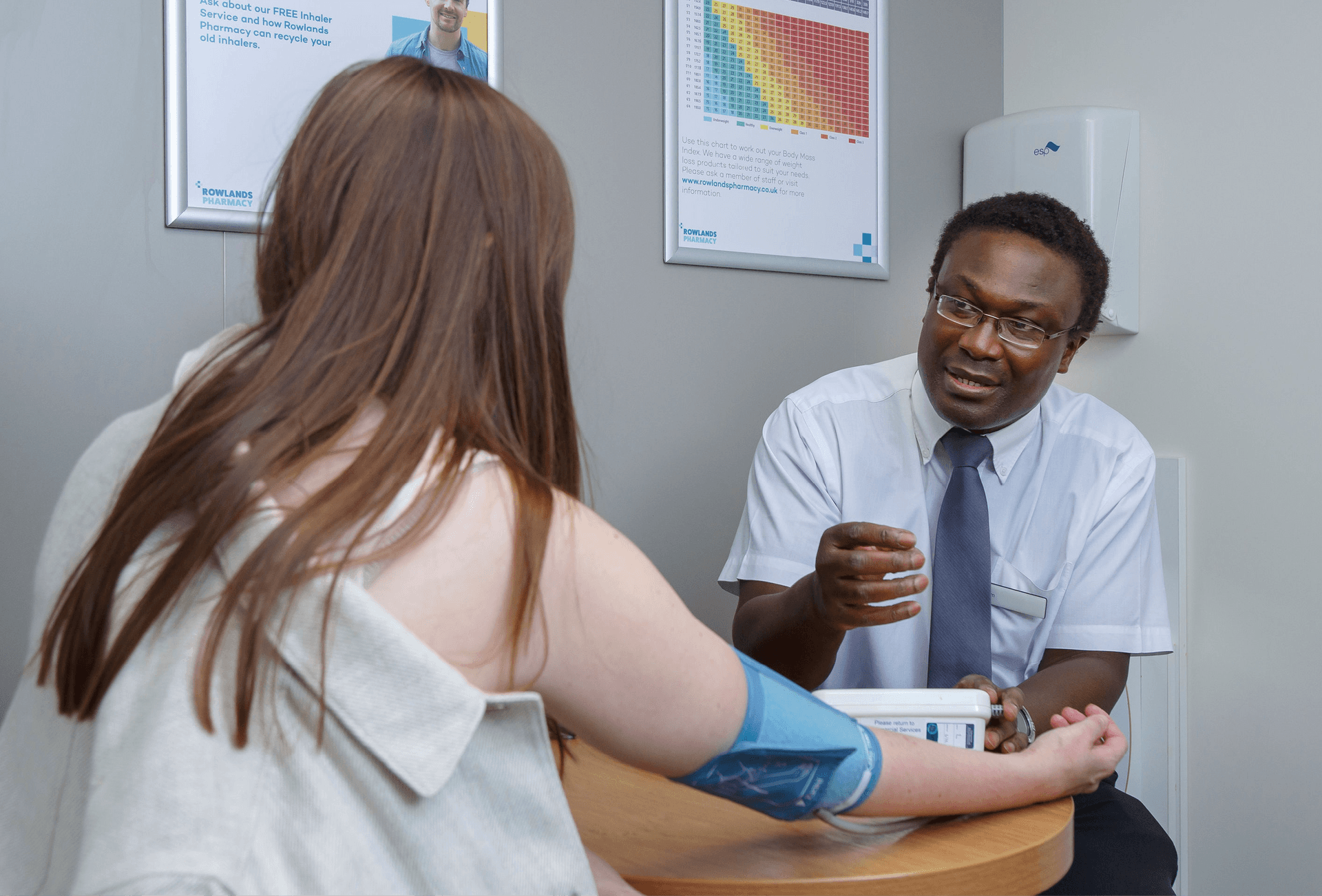 pharmacist performing a blood pressure check